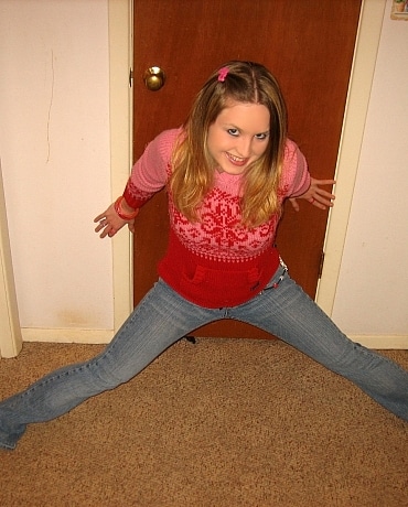 Kitty in jeans sitting on her apartment floor