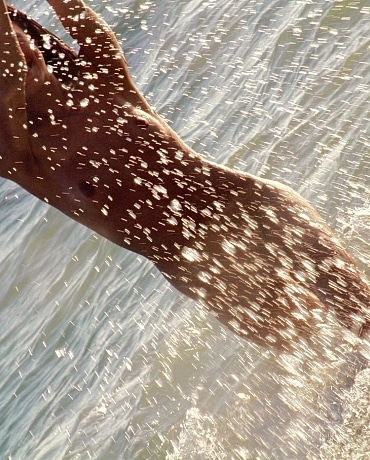 Layla nude splashing on the beach