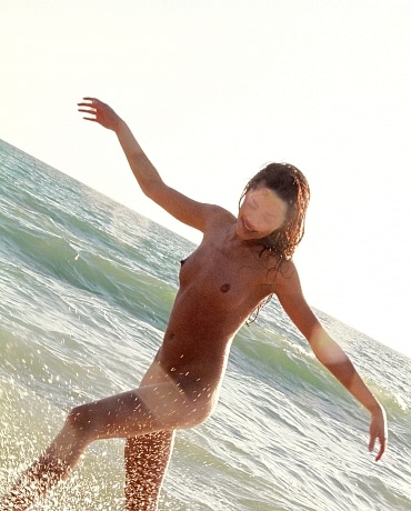 Layla nude splashing on the beach